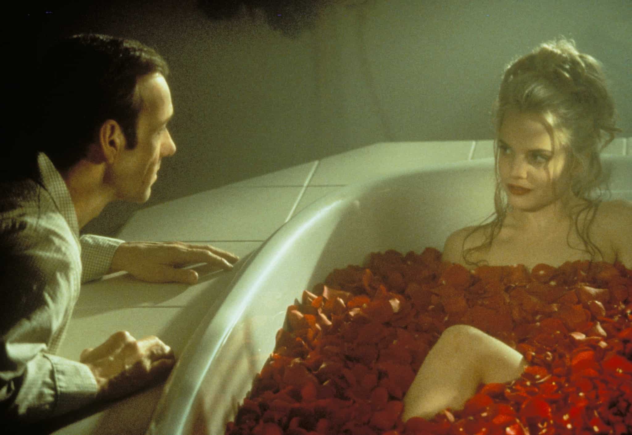 A man talks to a girl in a rose-filled tub in this photo from Dreamworks Pictures.