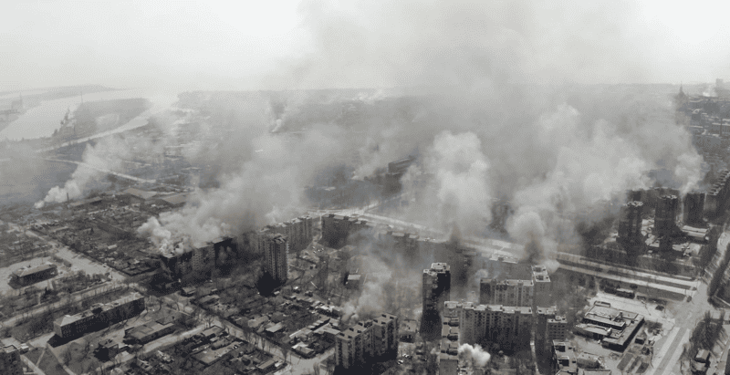 A city smolders in the wake of war in this image from Associated Press.