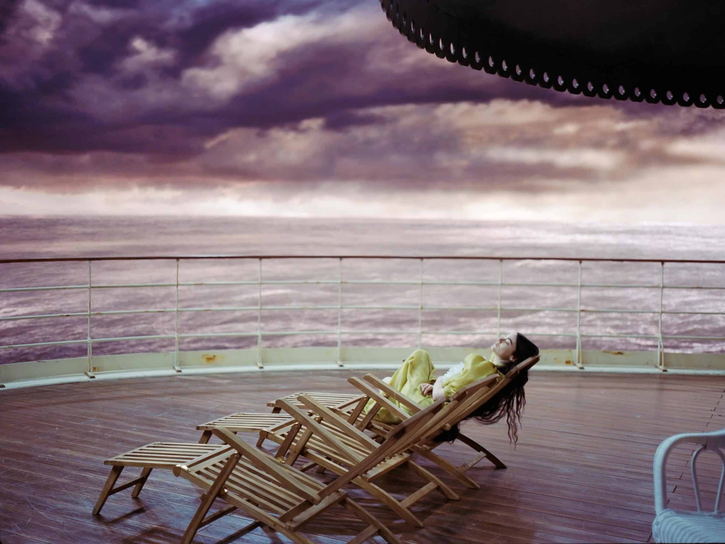 A young woman relaxes on the deck of a ship in this image from Element Pictures.