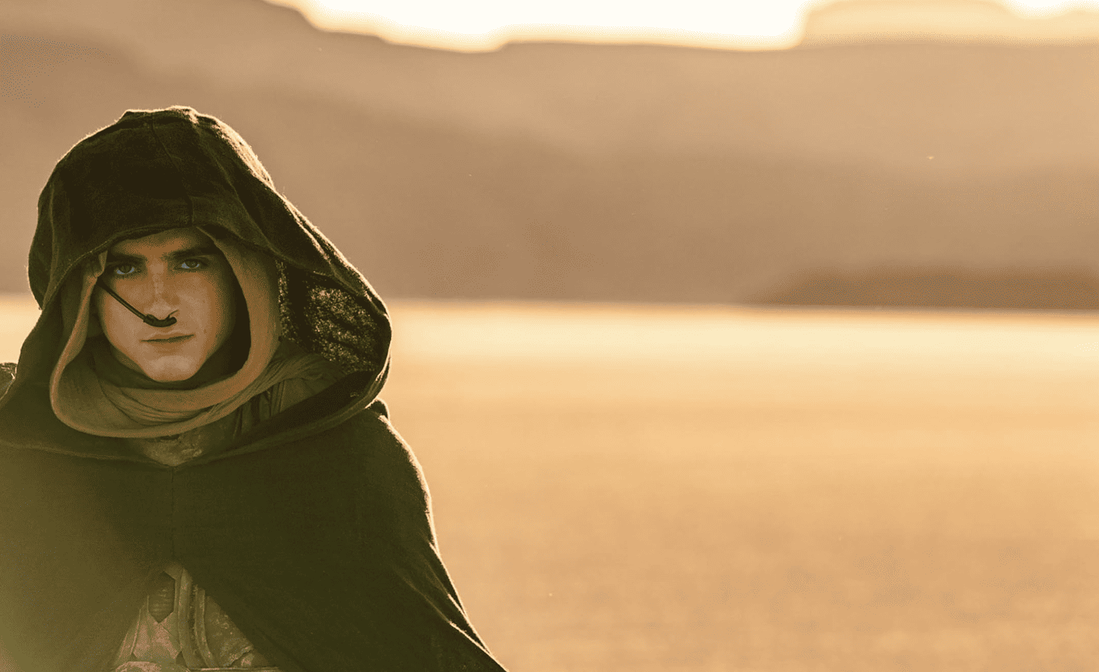 A cloaked man stands in the desert in this image from Legendary Entertainment.
