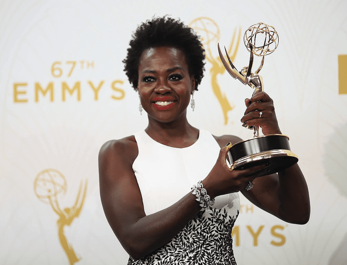 Viola holds up an Emmy award in this image from Mark Davis