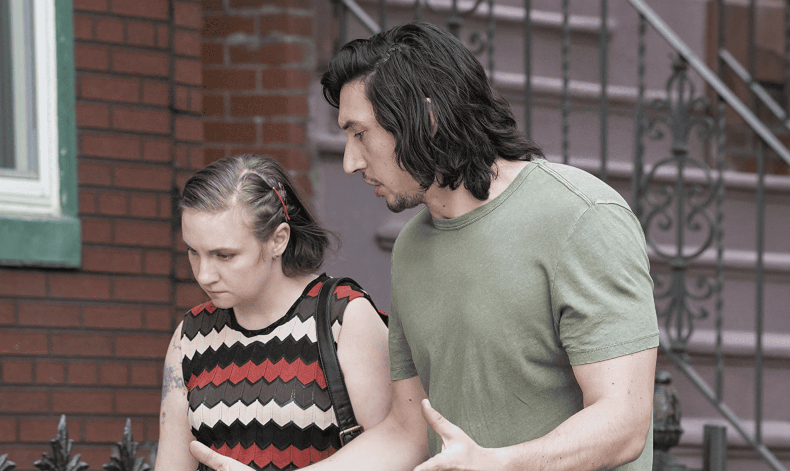 Adam and Hannah tensely walk the streets of Brooklyn in this image from Apatow Productions