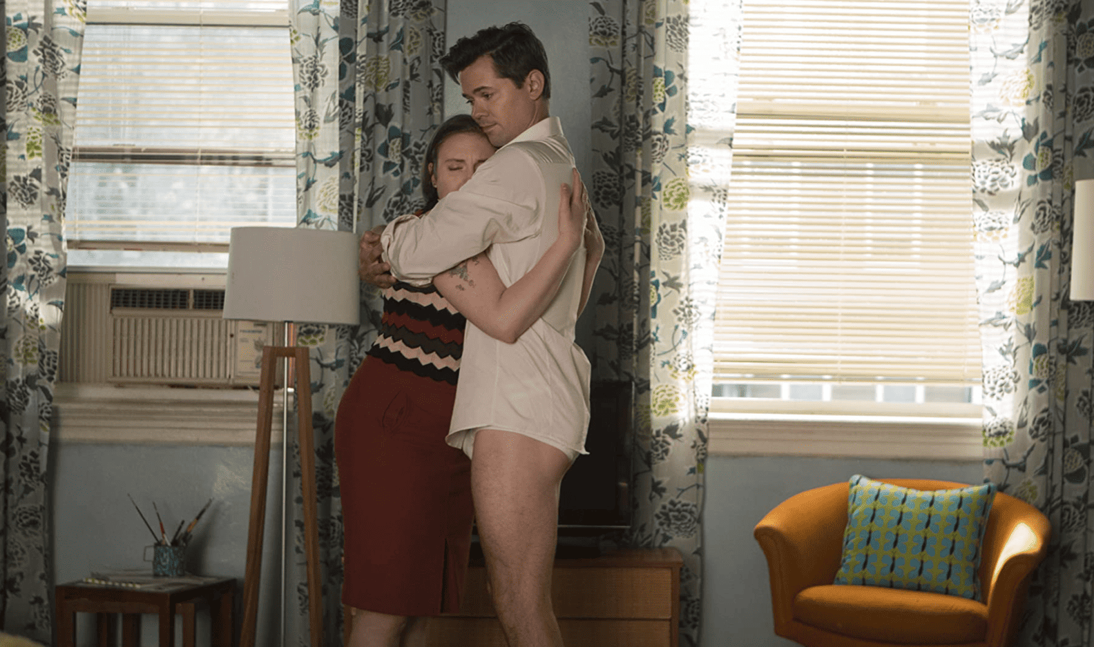 Hannah and Elijah embrace in their living room in this tender image from Apatow Productions