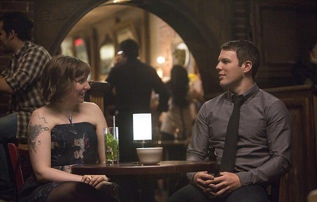Hannah and Fran sit in a darkly-lit bar in this image from Apatow Productions.
