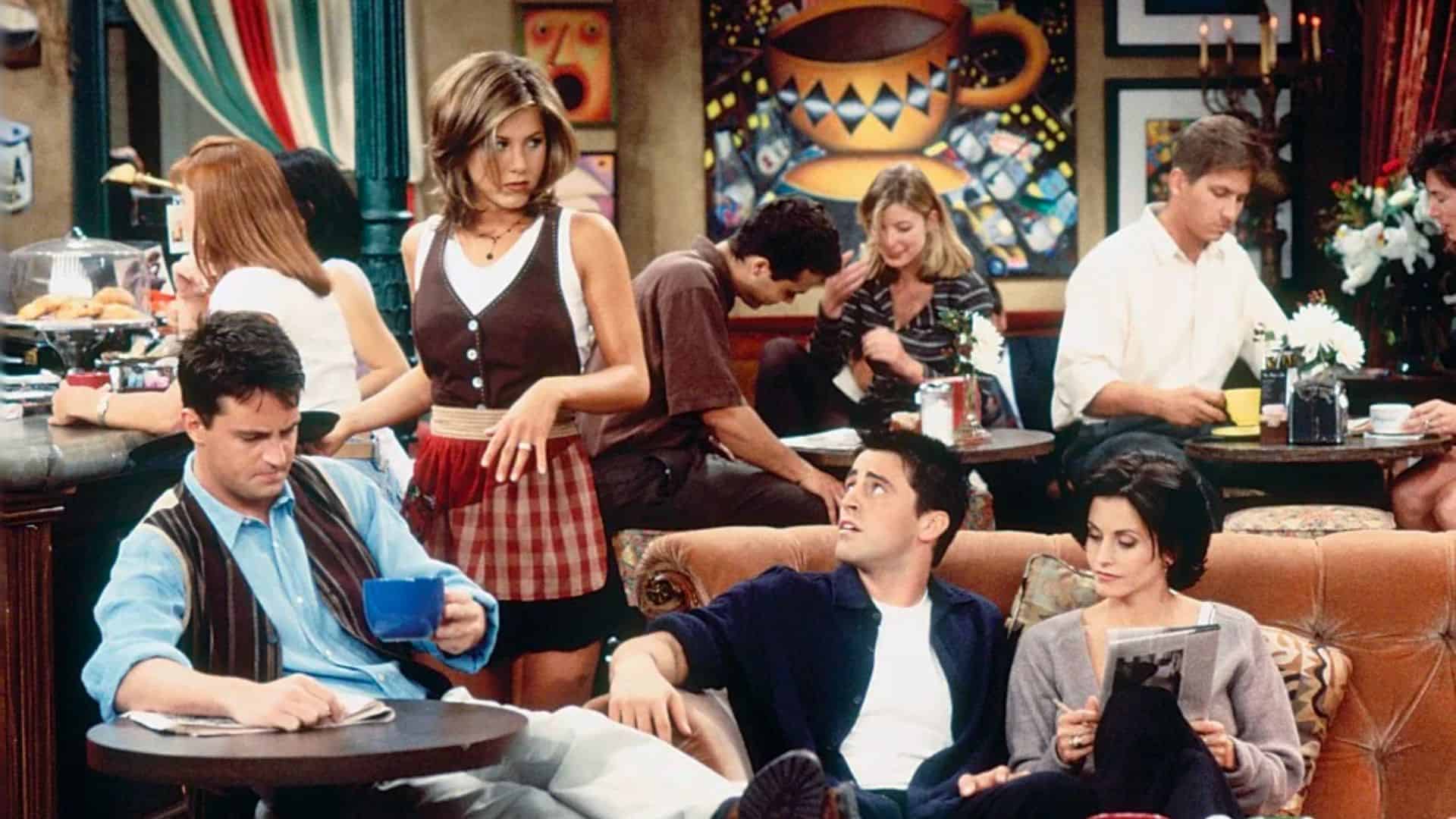 Rachel serves Chandler, Joey, and Monica at Central Perk in this image from Bright/Kauffman/Crane Productions
