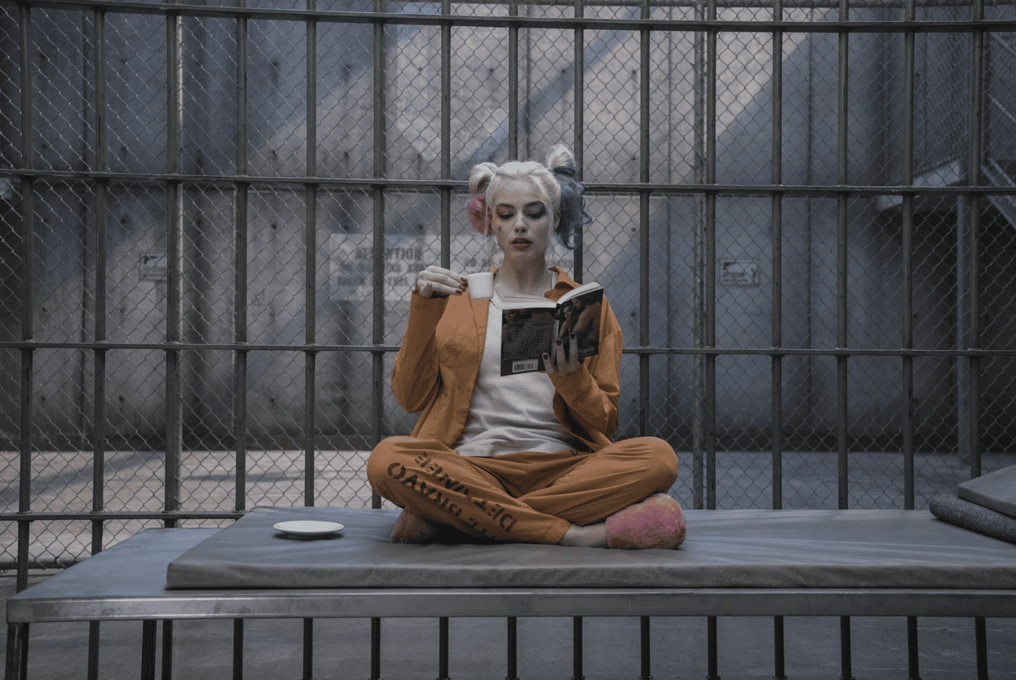 An female inmate sits with a book in this image from DC Entertainment