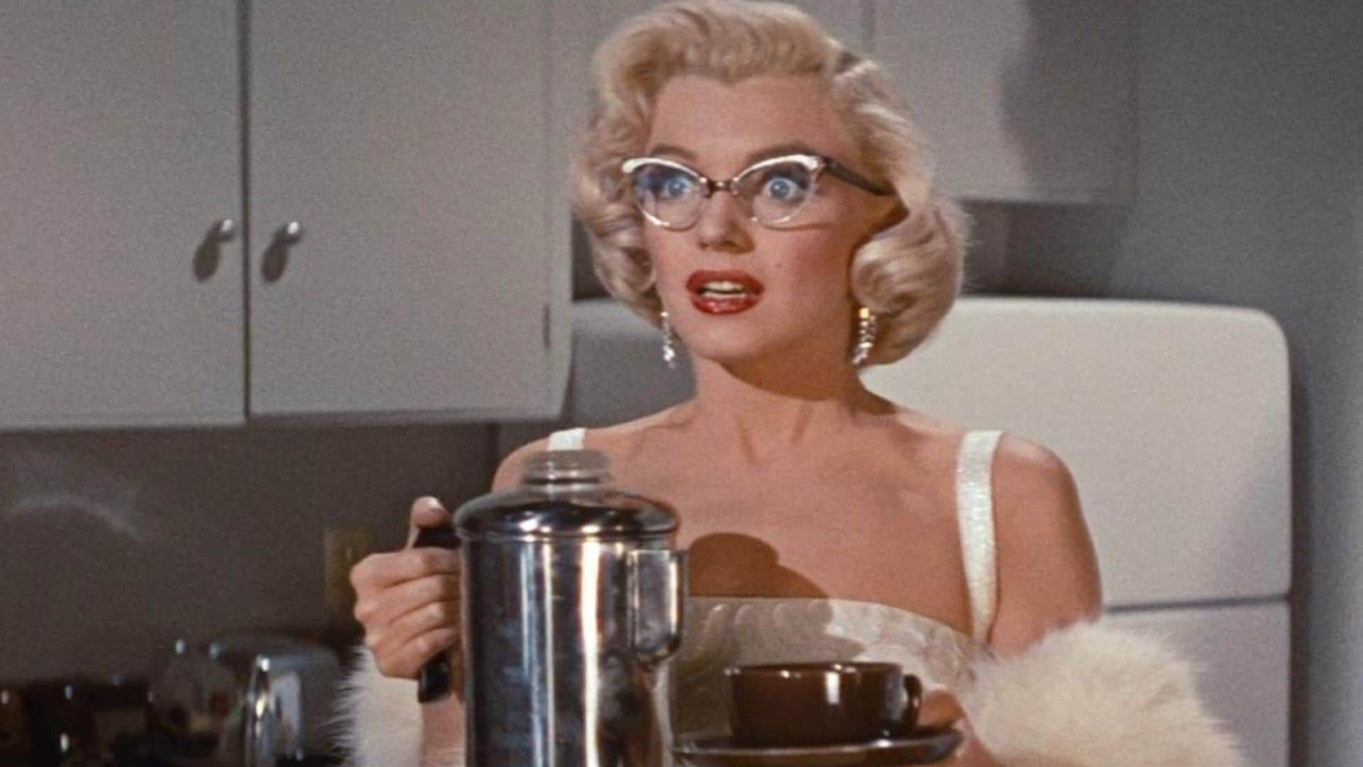 Pola Debevoise holds a mug and a pot of coffee in a kitchen in this image from Twentieth Century Fox
