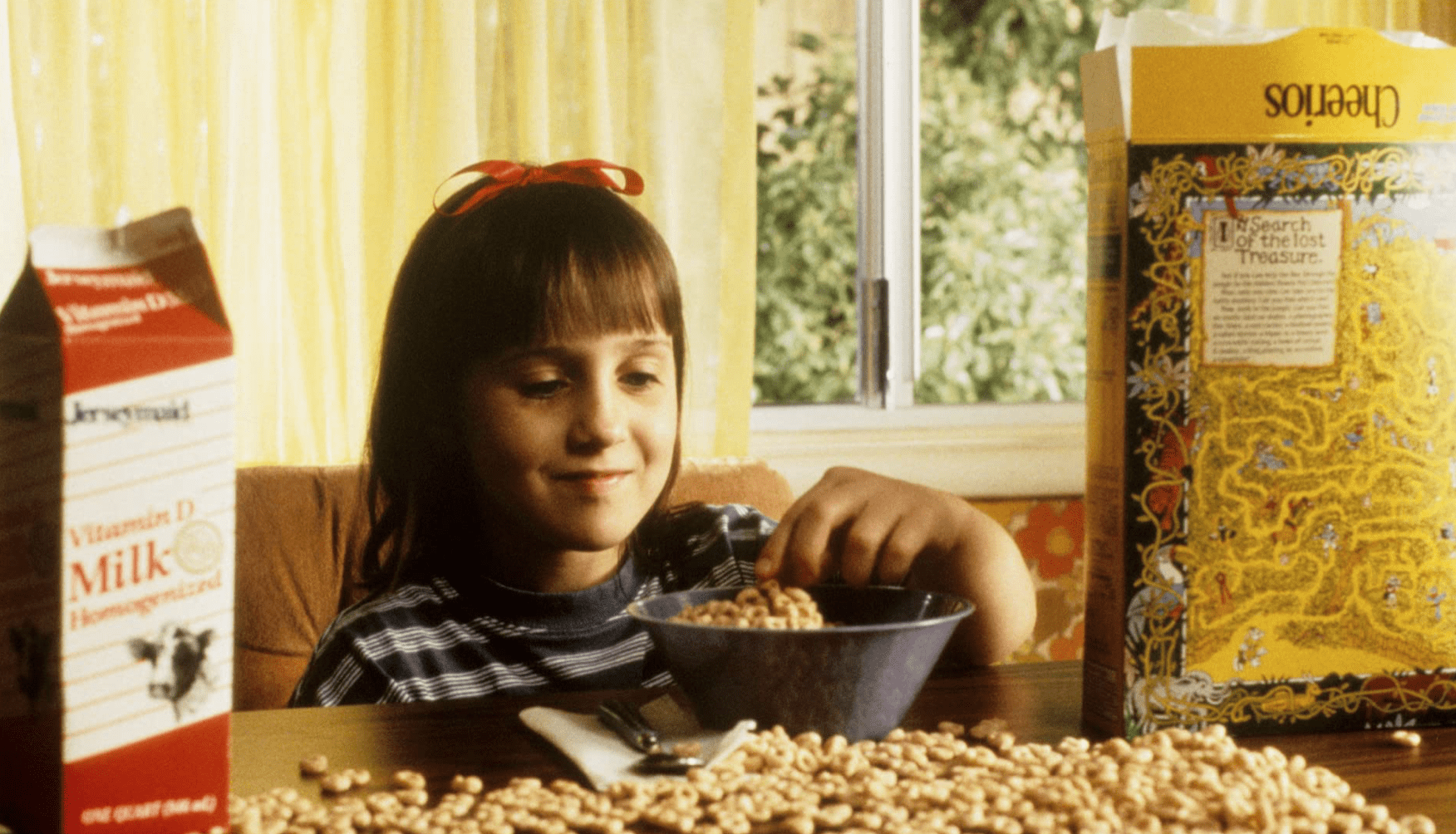 A young girl plays with her Cheerios in this image from Netflix