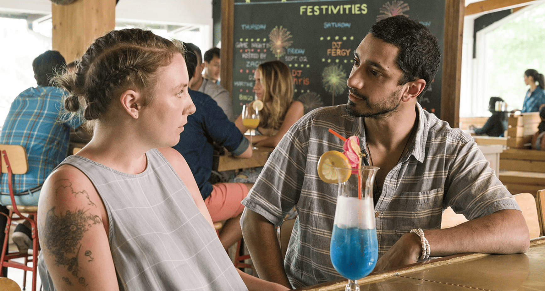Hannah and Paul-Louis share a drink at a bar in this image from Apatow Productions.