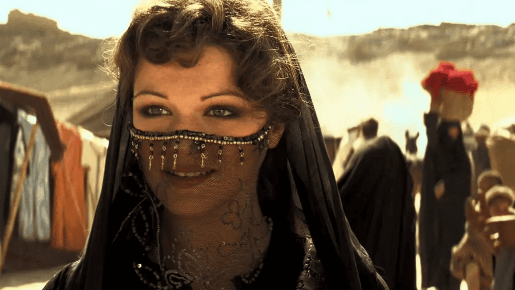 A woman in the desert with a jeweled lace veil in this image from Universal Pictures
