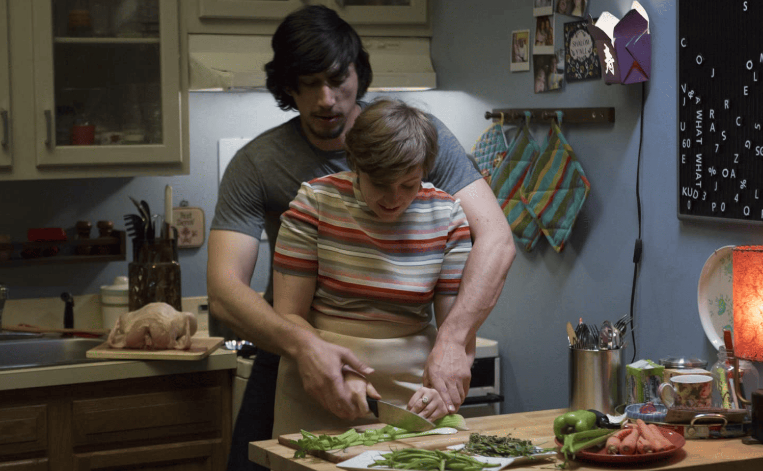 Hannah (Lena Dunham) and Adam (Adam Driver) cook together in this image from Apatow Productions