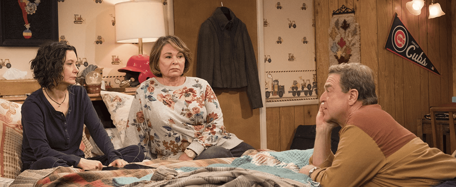 Roseanne sitting on her bed in this image from The Carsey-Werner Company
