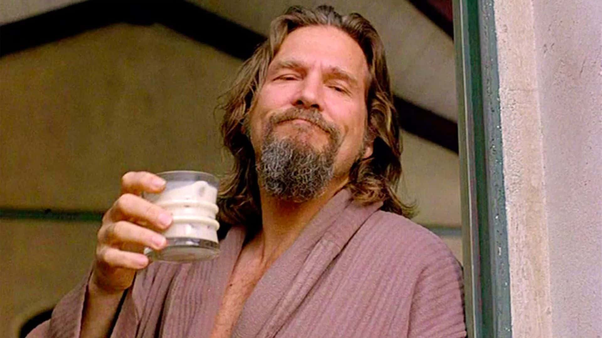 The Dude holds a White Russian while leaning in a doorway in this image from Working Title Films