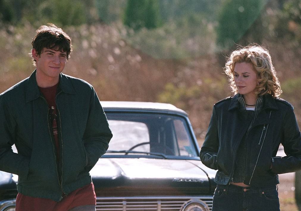 A couple standing in front of a car in this image from Tollin/Robbins Productions