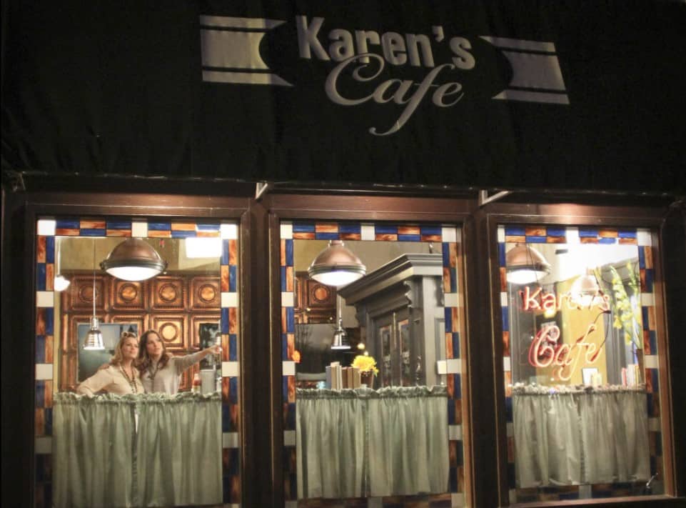 Two women standing inside a cafe from One Tree Hill in this image from Tollin/Robbins Productions/Warner Bros. Television