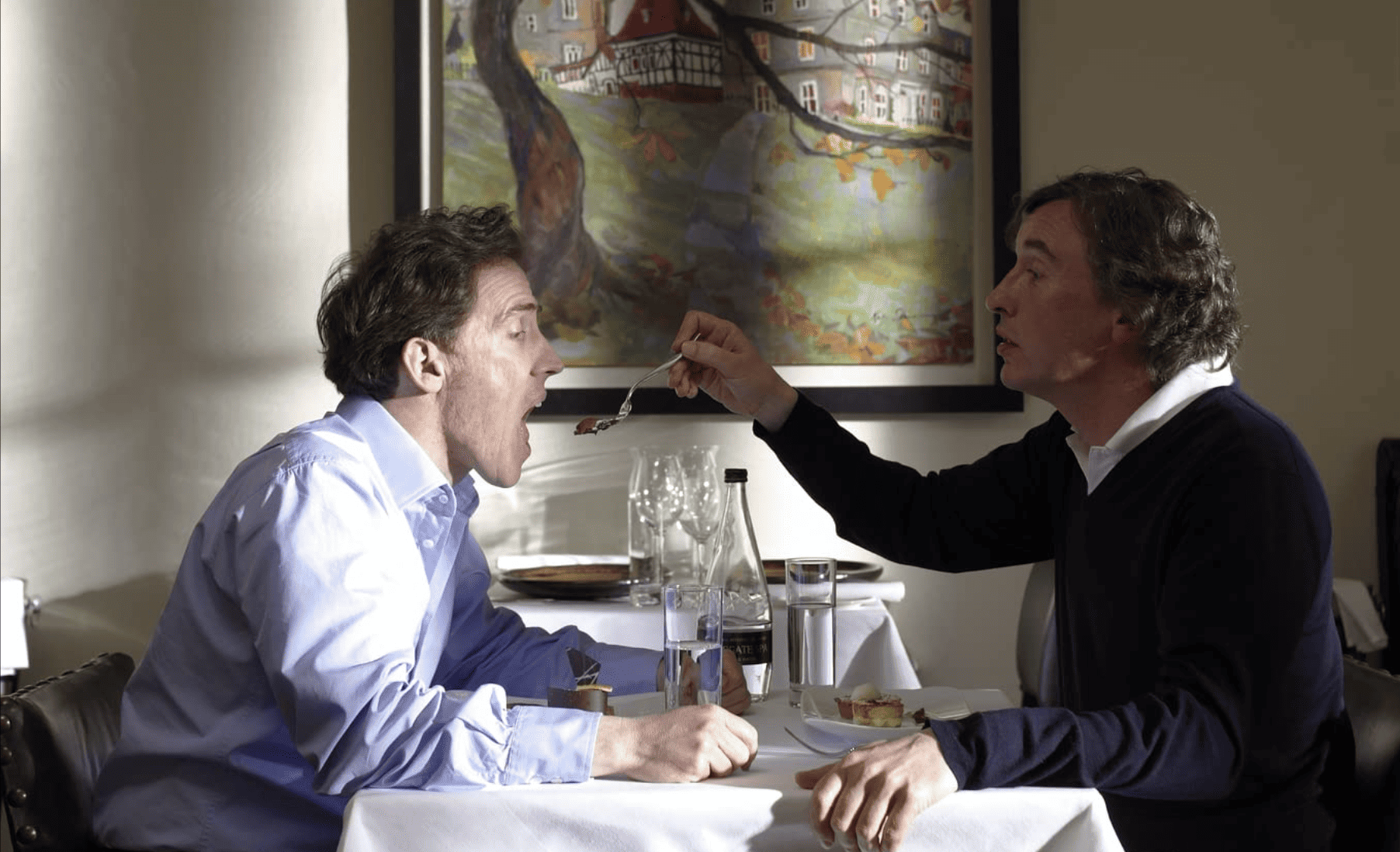 Two men at a restaurant in this image from Amazon Prime Video