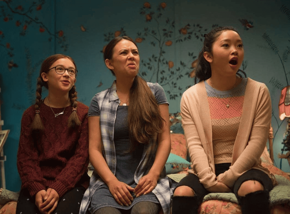 Three sisters react differently to something off camera in this image from All the Boys Productions