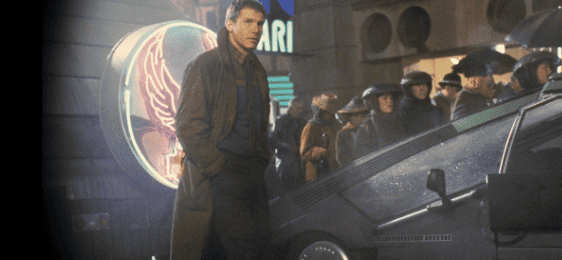  A man in a trench coat stands by a futuristic car in this image from The Ladd Company.