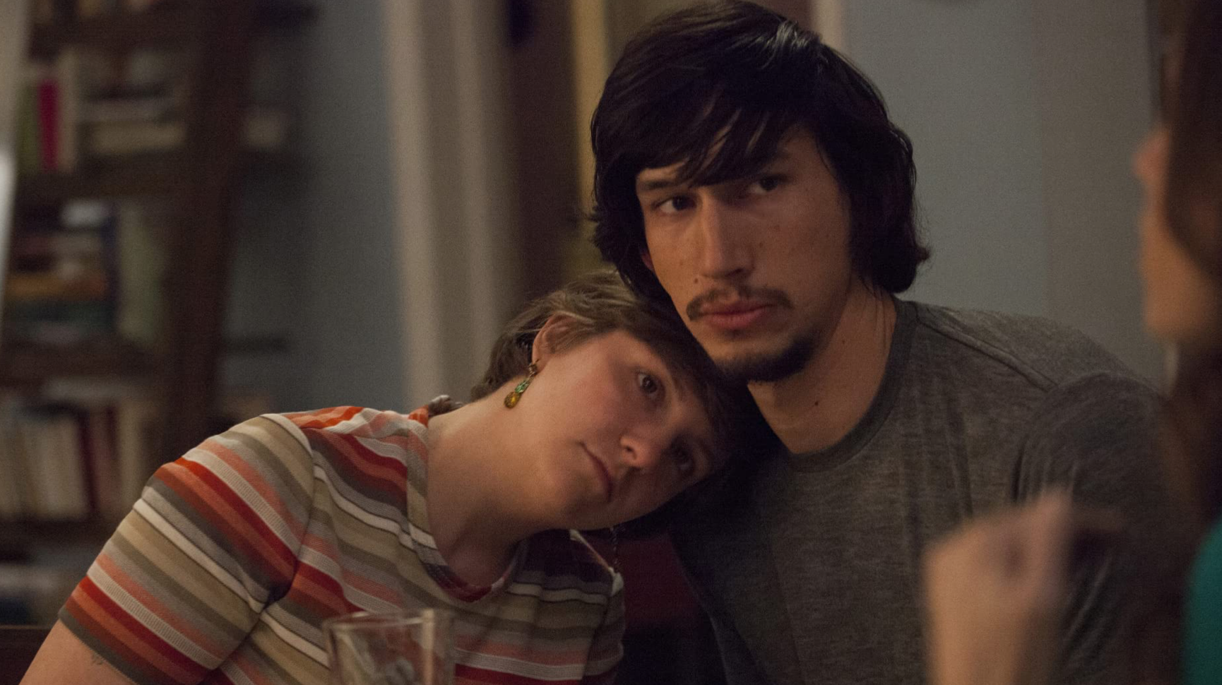 Lena Dunham and Adam Driver snuggling together in this image from Apatow Productions