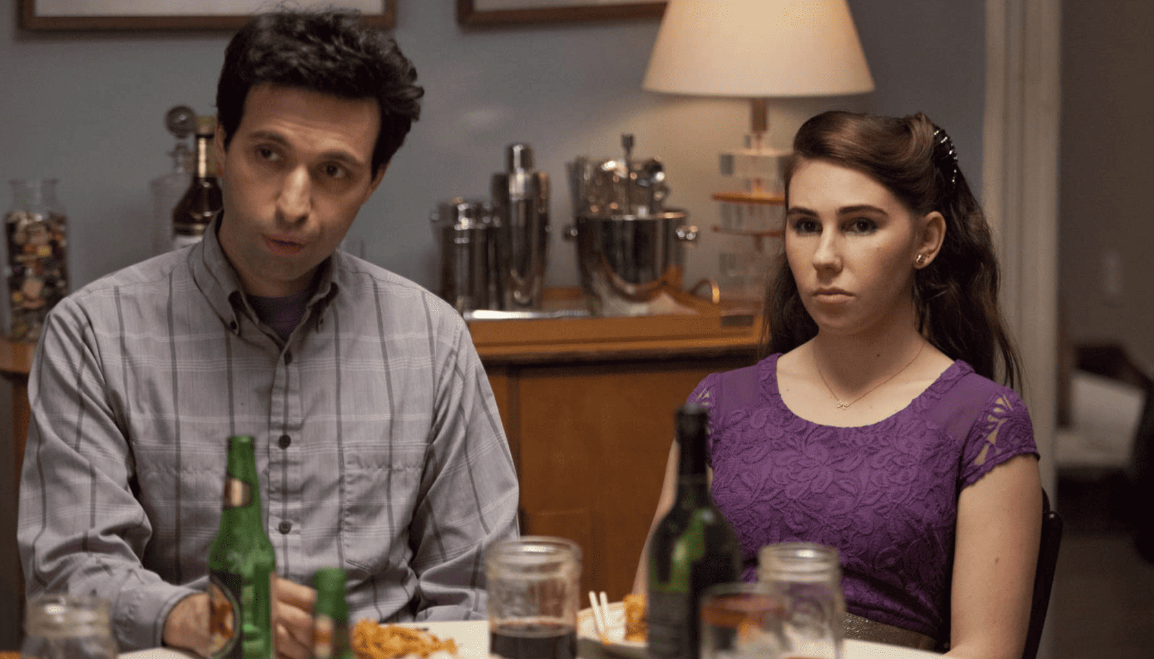 Ray and Shosh sitting together at the dinner table and staring off-camera in this image from Apatow Productions