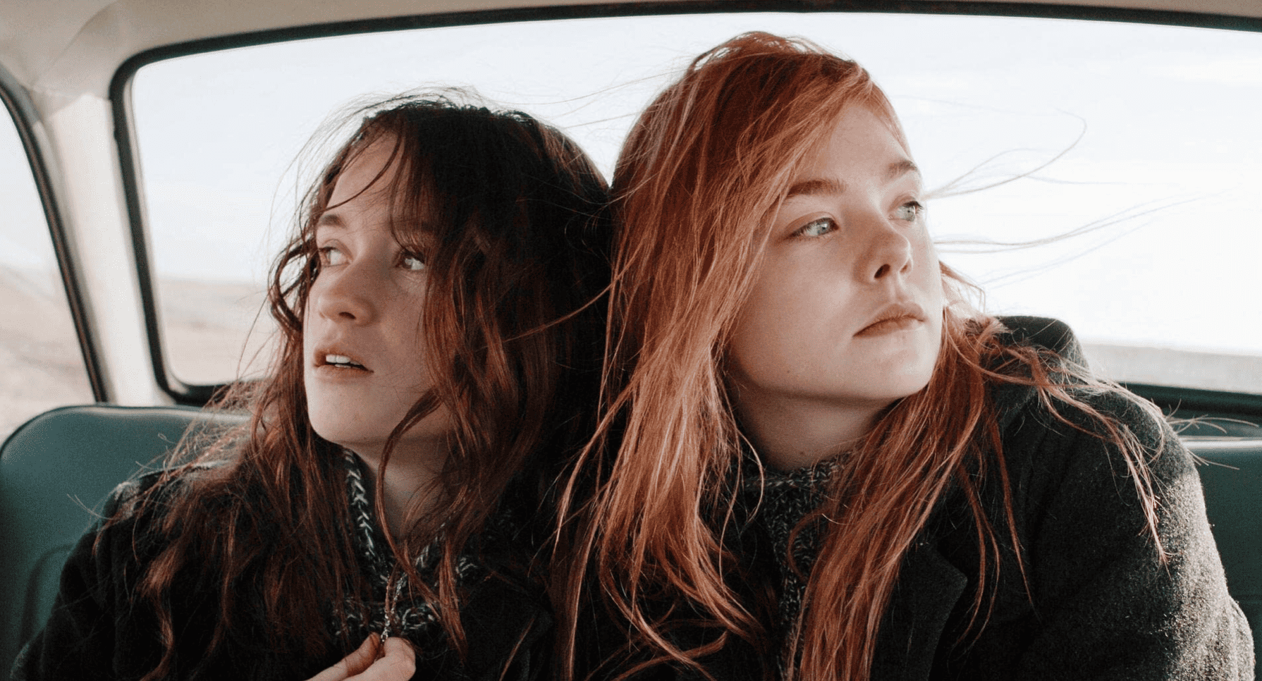 Rosa (Alice Englert) and Ginger (Elle Fanning) embrace each other in the backseat of a car in this image from British Film Institute