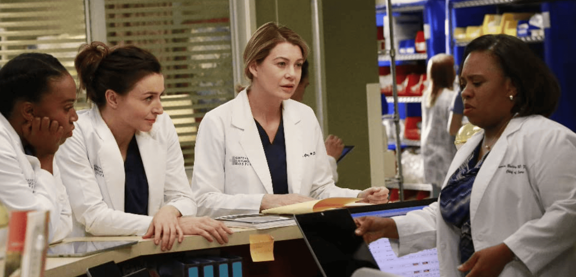 An unnamed woman, Amelia, Meredith, and Bailey standing around a desk in this image from ABC Studios.