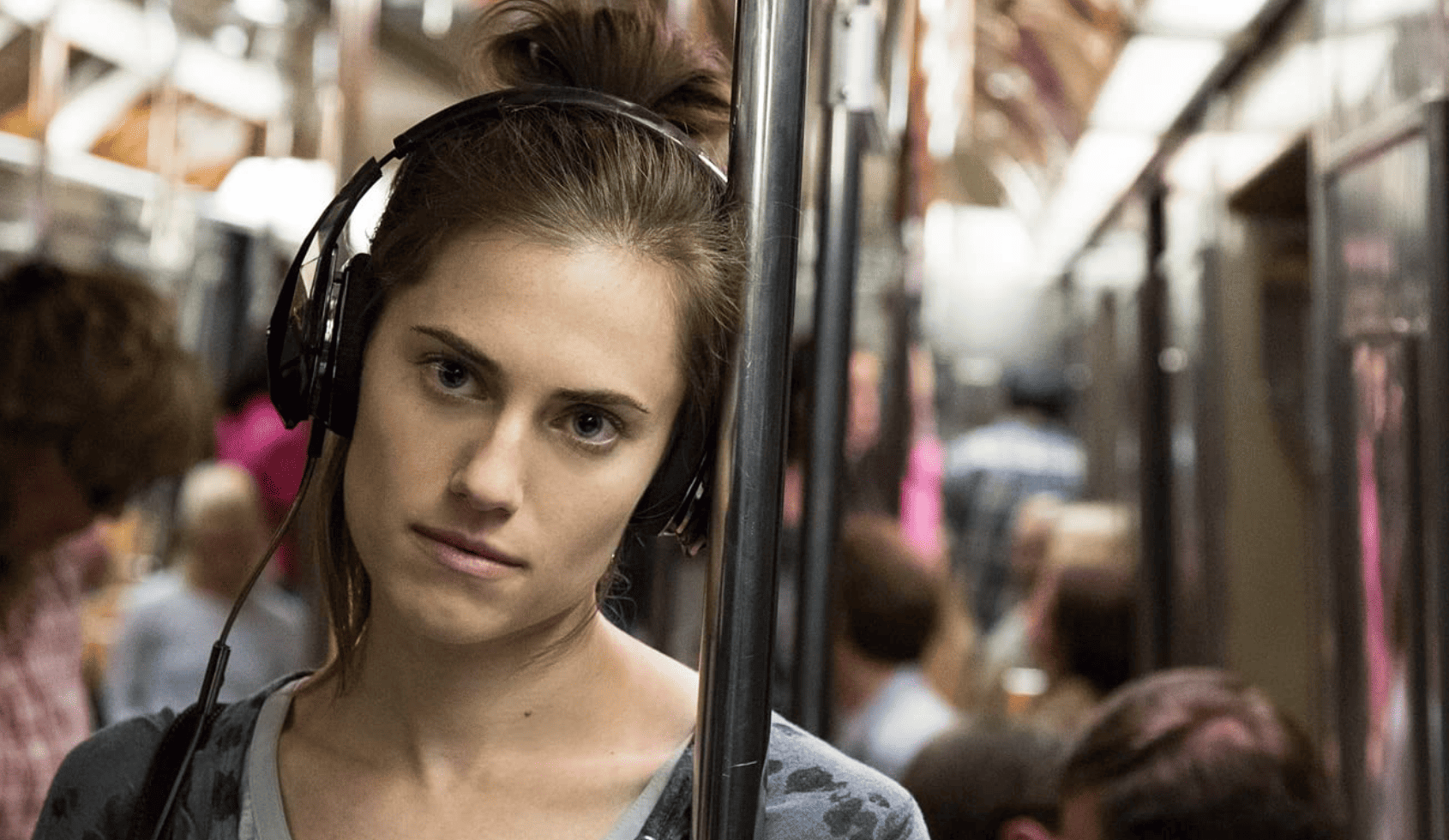 Marnie (Allison Williams) looks defeated while riding the train alone in this image from Apatow Productions