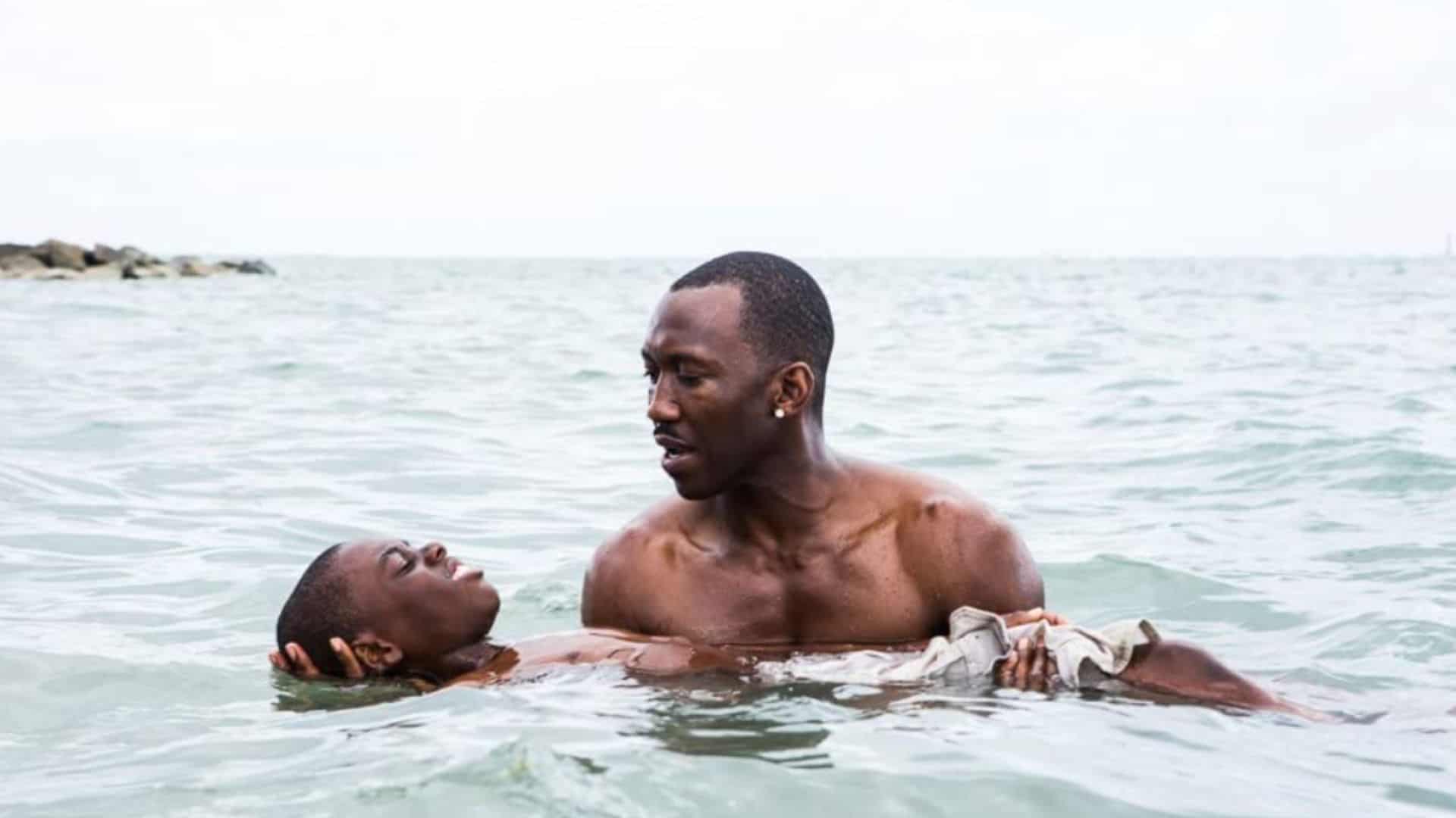 Mahershala Ali helps Alex R. Hibbert float in the water in this image from A24.