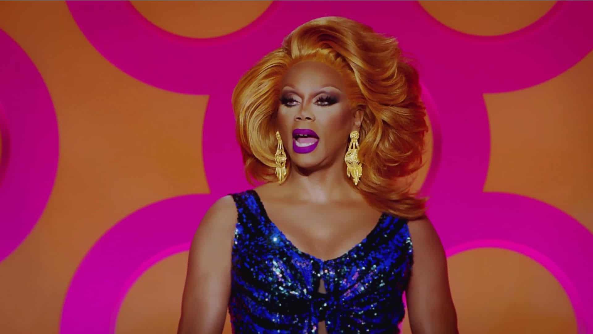 RuPaul is wearing a black and blue sequin dress in this image from World of Wonder.