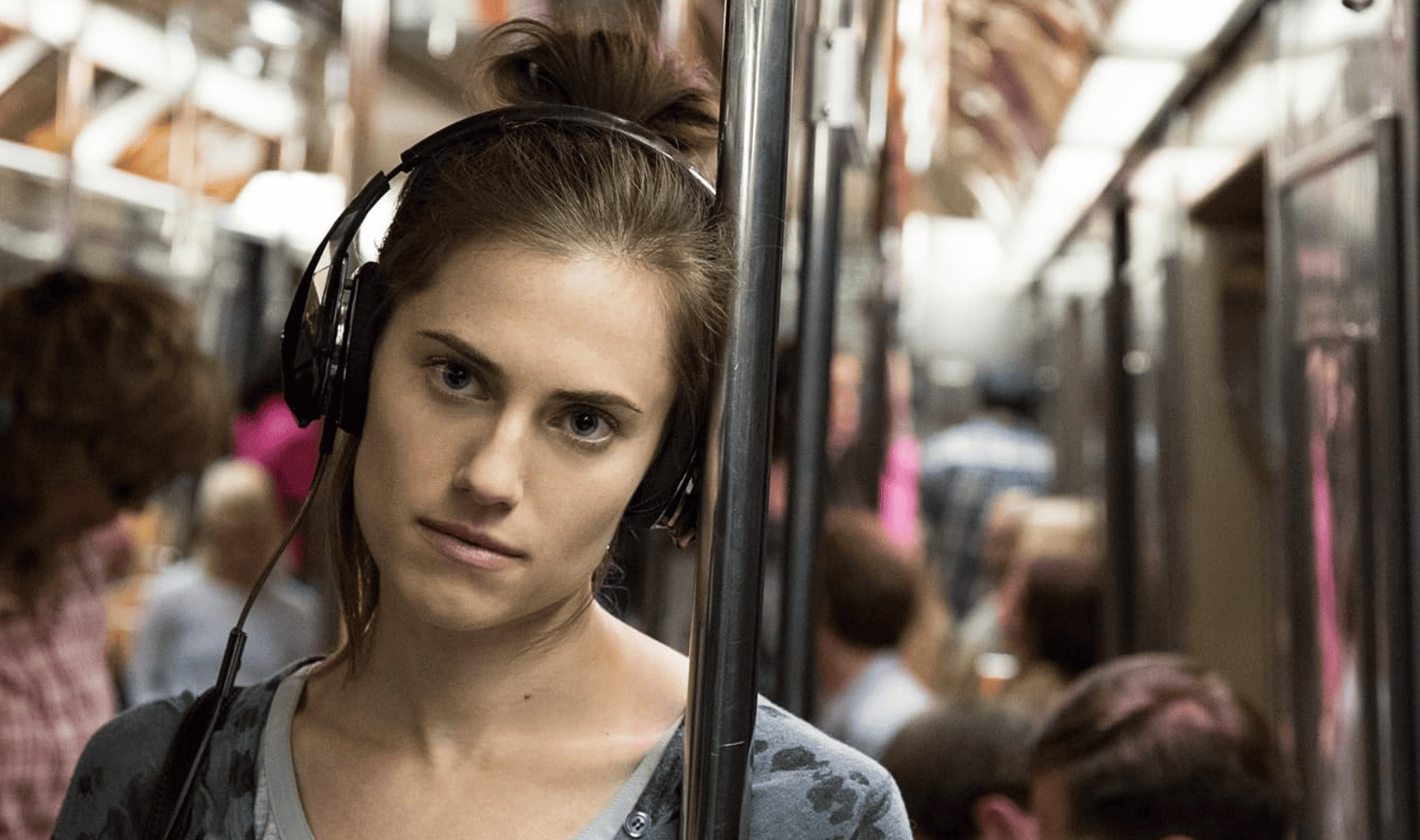 Marnie listens to some tunes while wearing her headphones on the subway in this image from Apatow Productions.