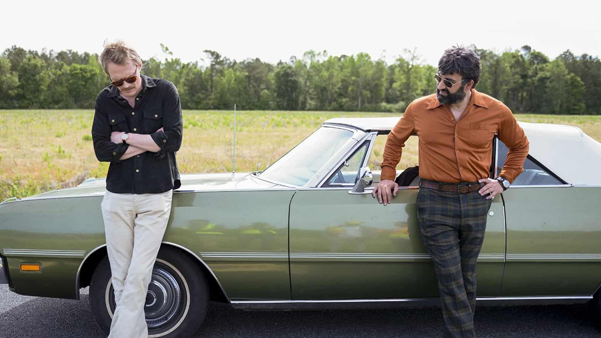 Frank and Wally lean against a car in this image from Amazon Studios