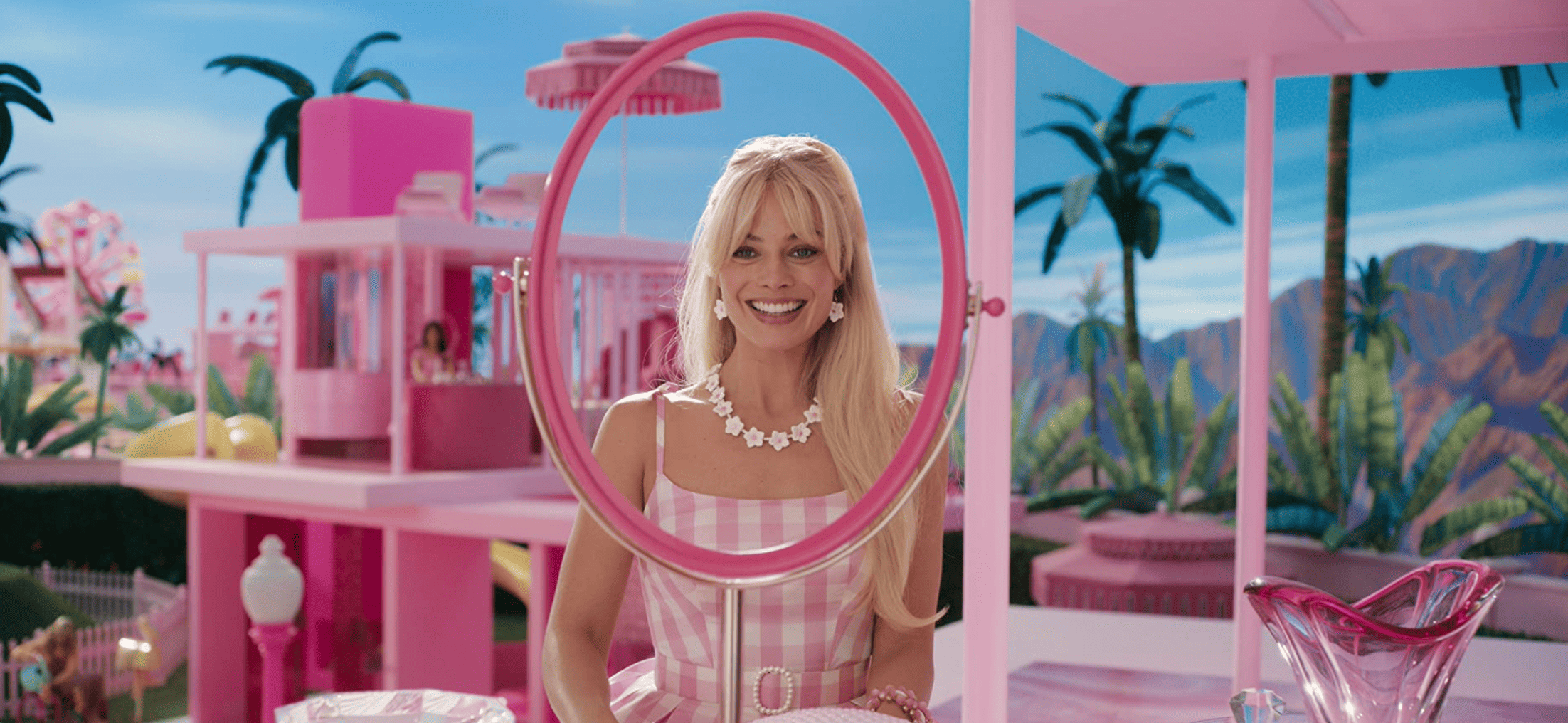 Margot Robbie as Barbie staring at an empty mirror in this image from HeyDay Films