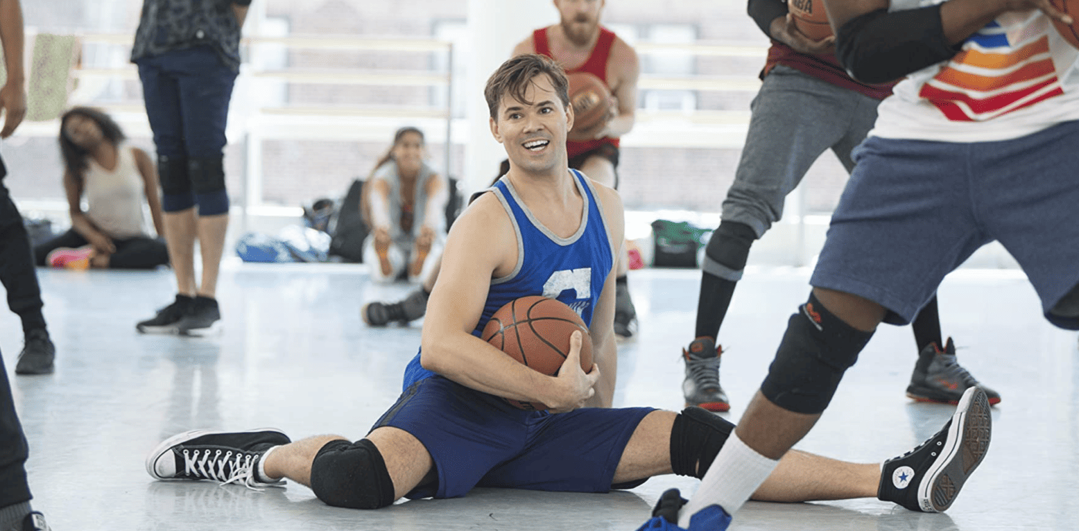 Elijah attempting to do the splits while also holding a basketball in this image from Apatow Productions