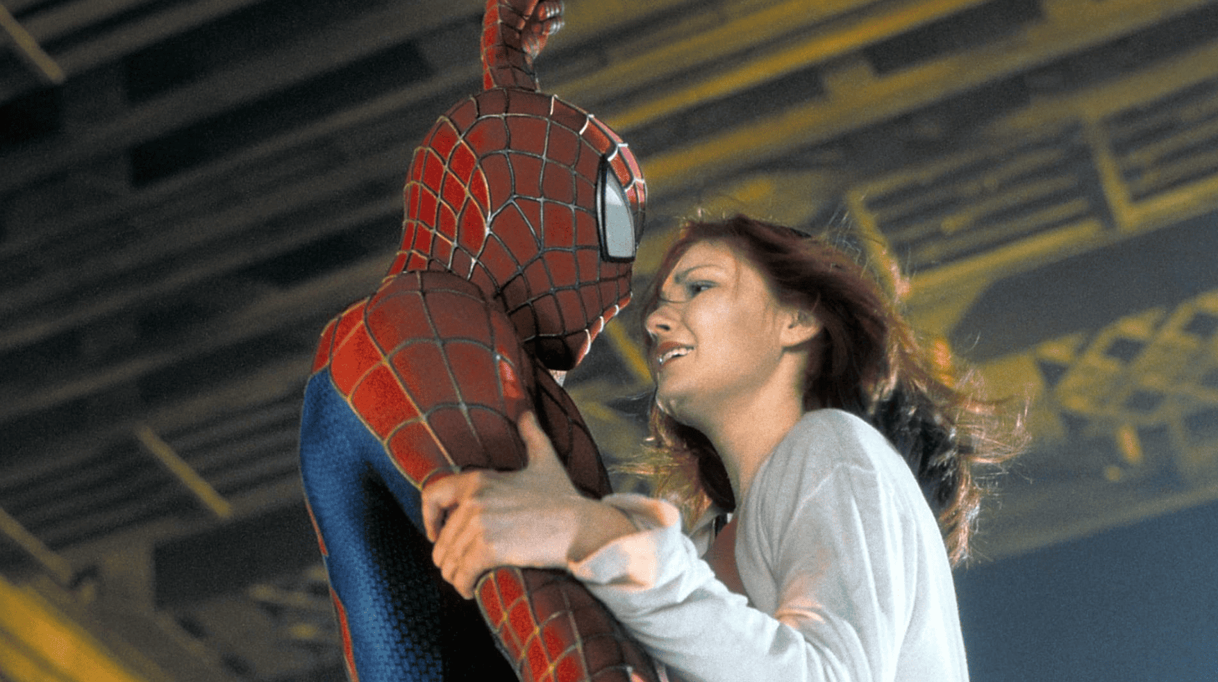 Spider-Man catching Mary Jane while hanging from his spiderweb in this image from Columbia Pictures