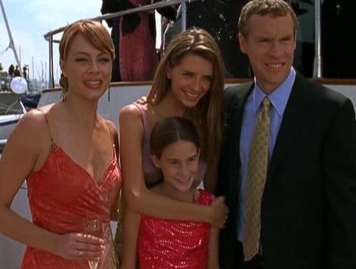 A family stands by a boat in this image from Warner Bros. Studios