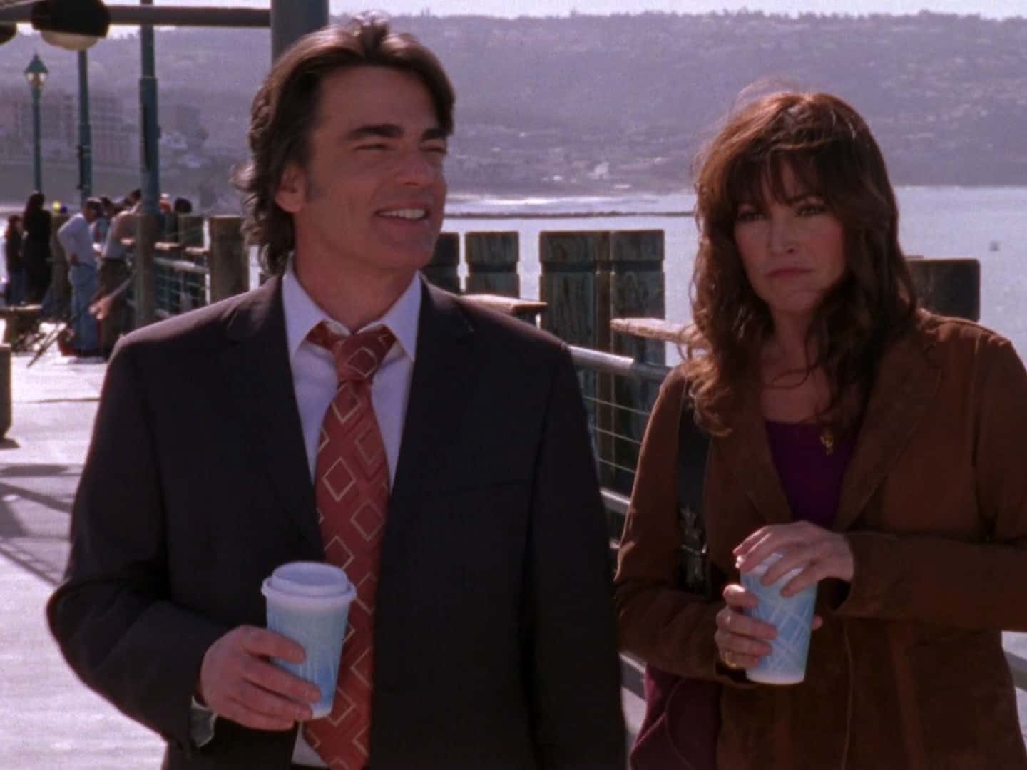 A man and a woman holding coffee cups in this image from Warner Bros. Studios
