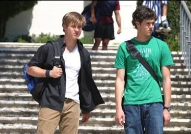 Two students stand on school steps in this image from Warner Bros. Studios