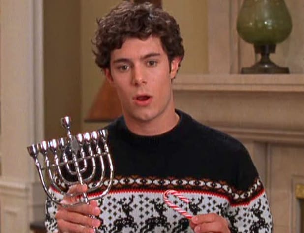 A man holds a menorah in this image from Warner Bros. Studios.