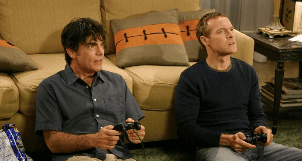 Two men playing video games in this image from Warner Bros. Studios