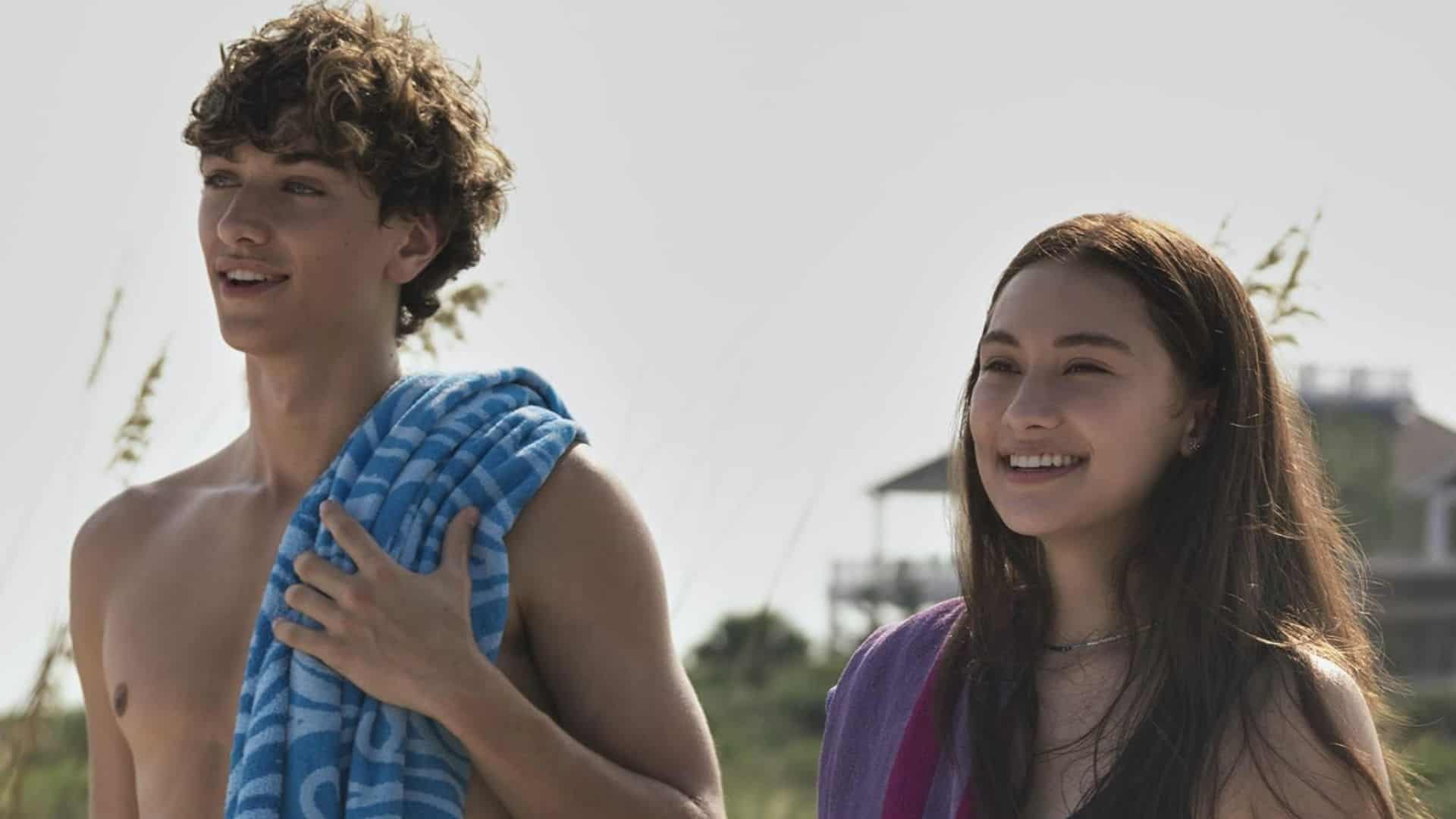 Gavin Casalegno and Lola Tung with beach towels over their shoulders in this image from Amazon Studios