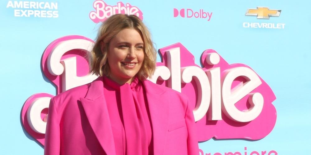 Greta Gerwig smiles on the pink carpet in this image from Shutterstock