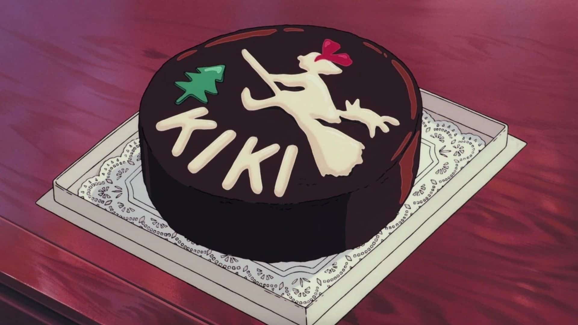 A frosted cake depicting Kiki flying on her broom in this image from Studio Ghibli