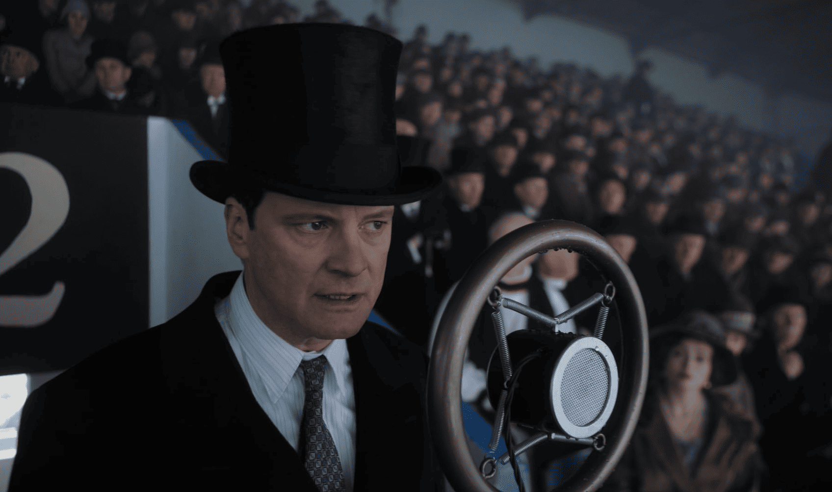 Colin Firth as King George VI delivering a speech inside a crowded stadium in this image from Momentum Pictures