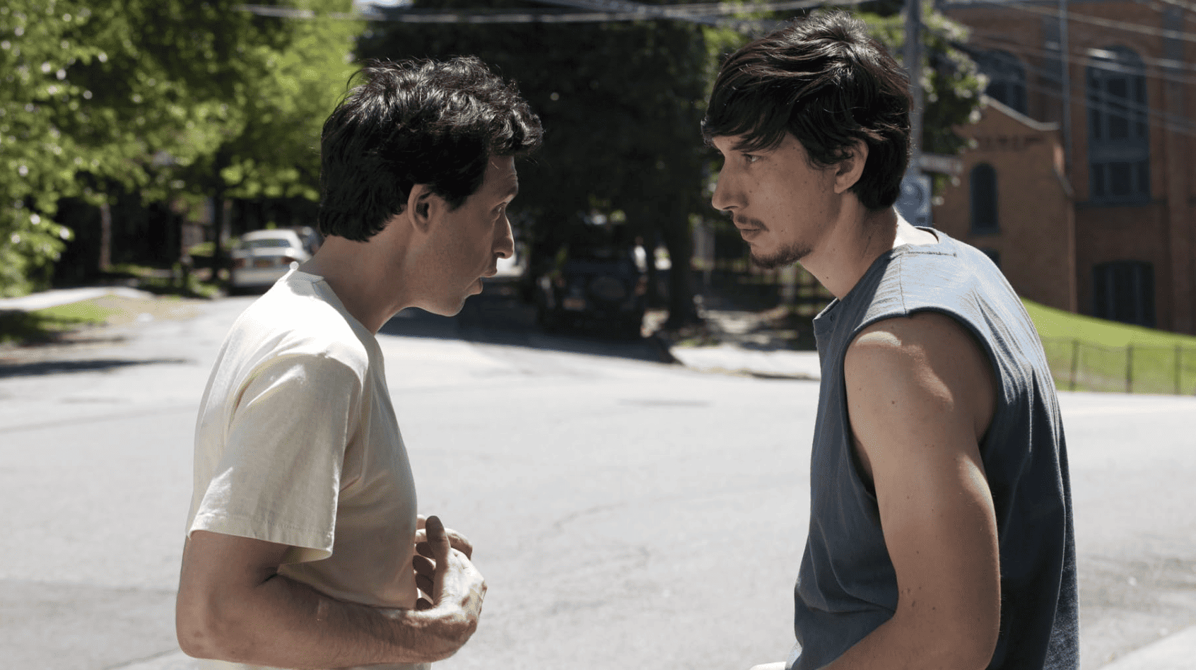 Alex Karpovsky and Adam Driver standing under the scorching sun in this image from Apatow Productions