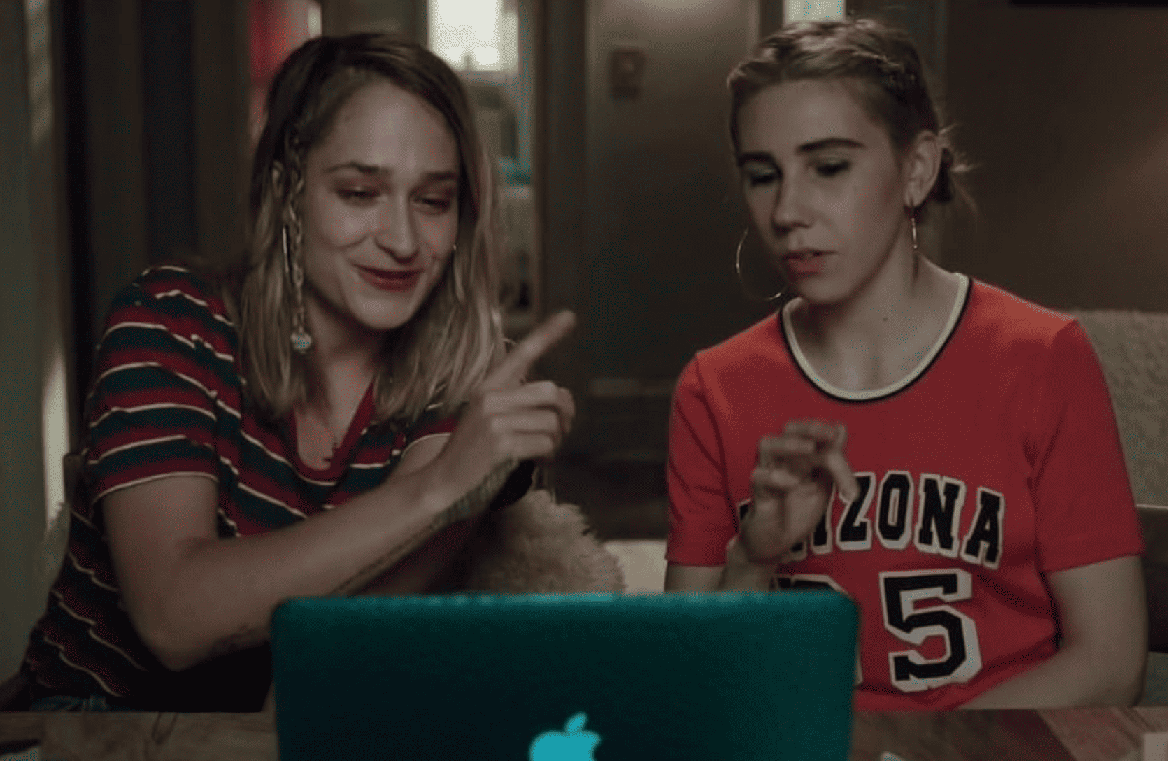 Jemima Kirke and Zosia Mamet sitting in front of a laptop on what appears to be a video call in this image from Apatow Productions