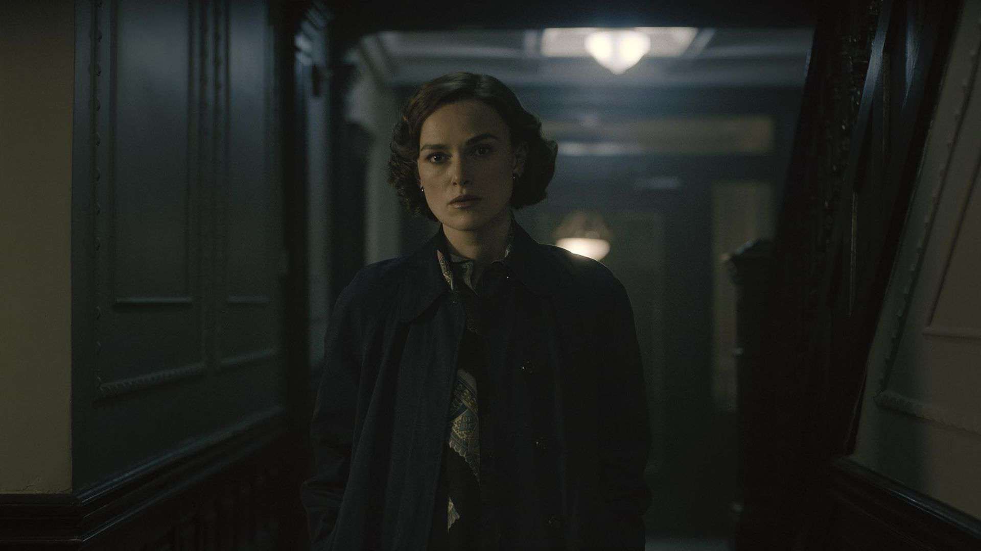 Keira Knightley walking down a dark hallway in this image from 20th Century Studios.