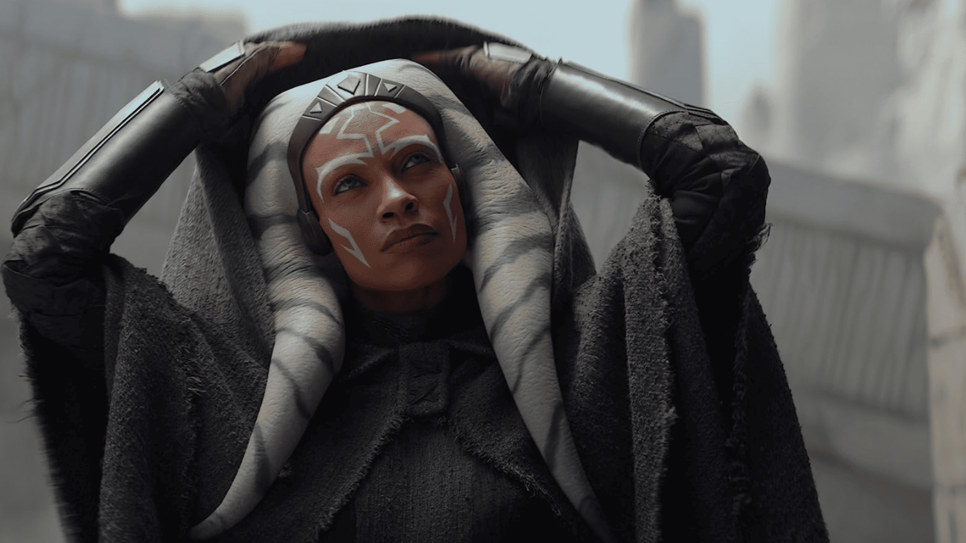 Rosario Dawson reveals her face from beneath a hooded cloak in this image from Lucasfilm
