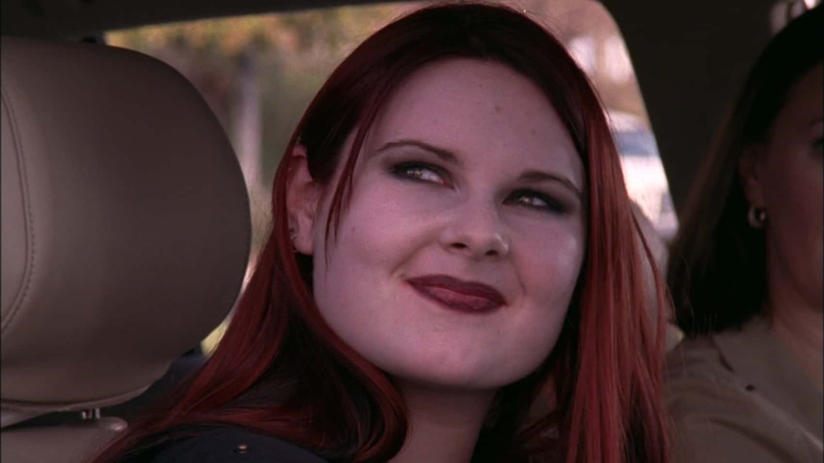 A woman smiles while looking out a car window in this image from Tollin/Robbins Productions