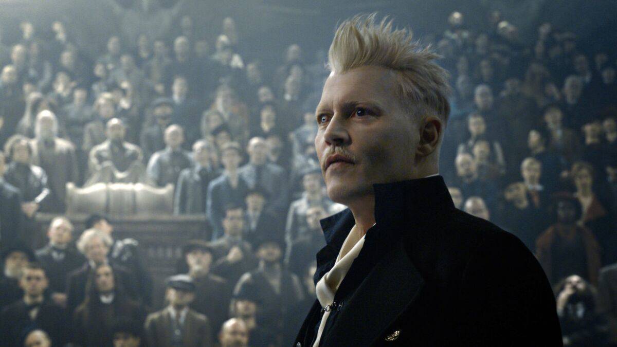 A man with white hair stares in front of a crowd in this image from Warner Bros. Pictures.