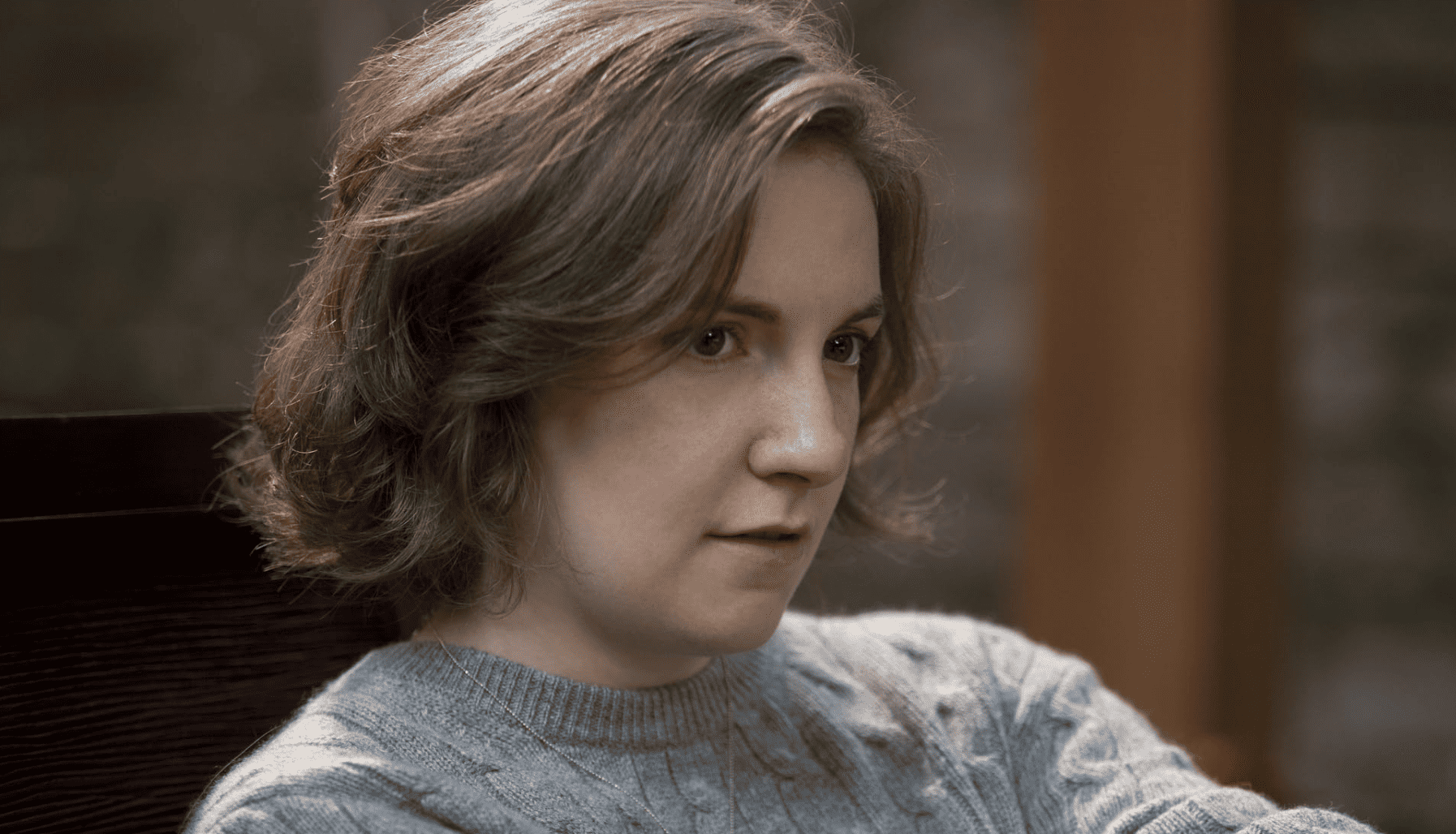 A pensive Lena Dunham as Hannah Horvath stares intently into the distance in this image from Apatow Productions